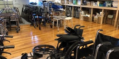 Wheelchairs and other medical equipment stored in a room
