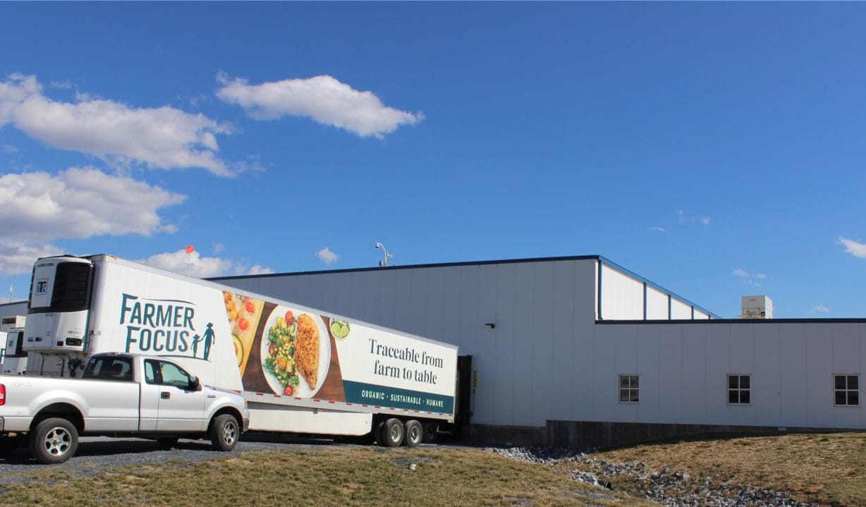 A truck trailer in front of a building