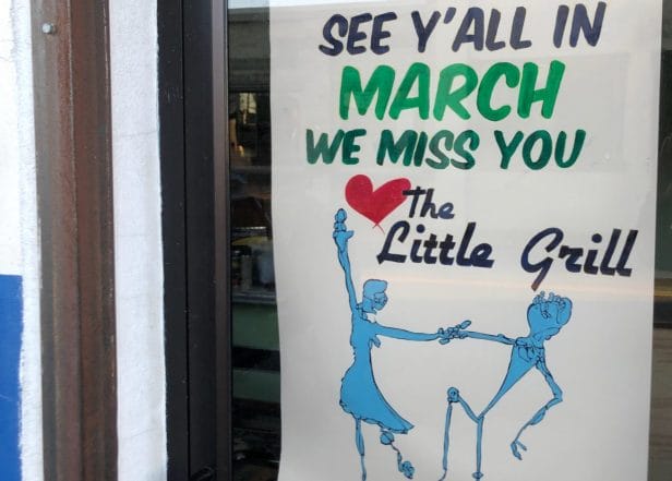 A sign that says "See Y'All in March. We miss you. Love, the Little Grill"