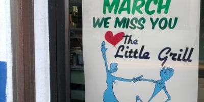 A sign that says "See Y'All in March. We miss you. Love, the Little Grill"