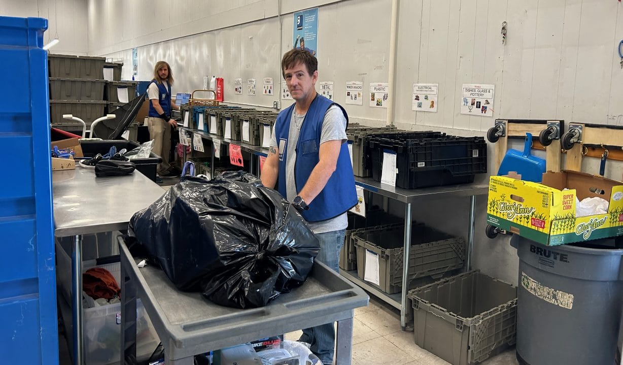 Two men working with bags and boxes