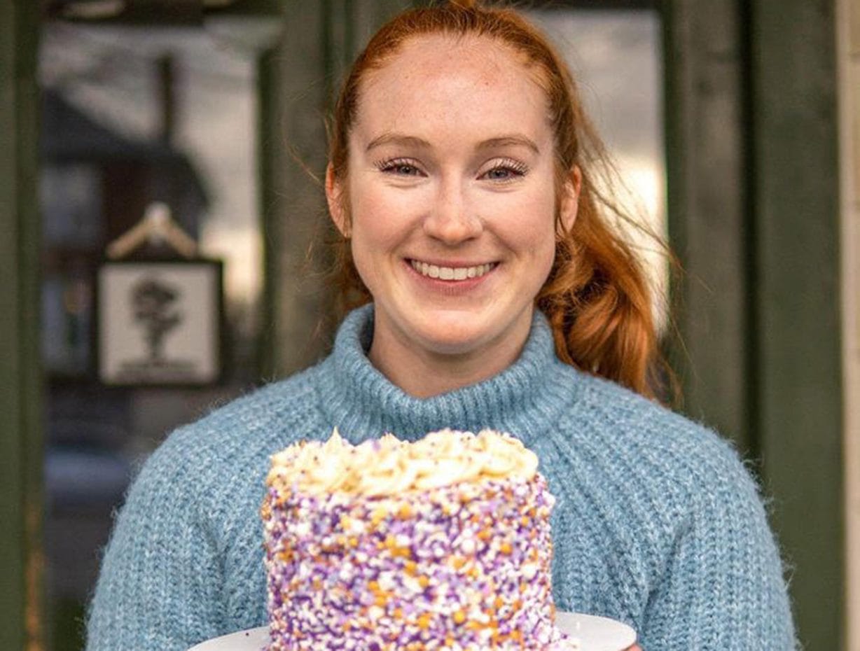 A woman holding a cake