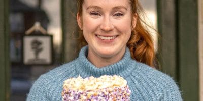 A woman holding a cake