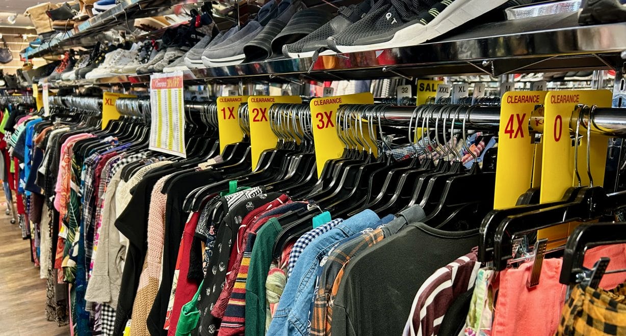 Clothes on a rack separated by sizes
