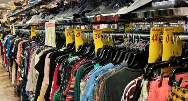 Clothes on a rack separated by sizes