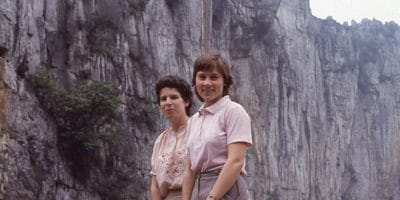 Two women standing in front of a cliff