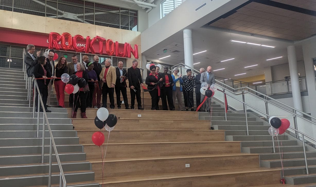 People standing on steps with balloons around them