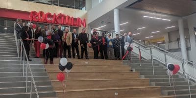 People standing on steps with balloons around them