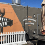 A food truck trailer next to a picnic table