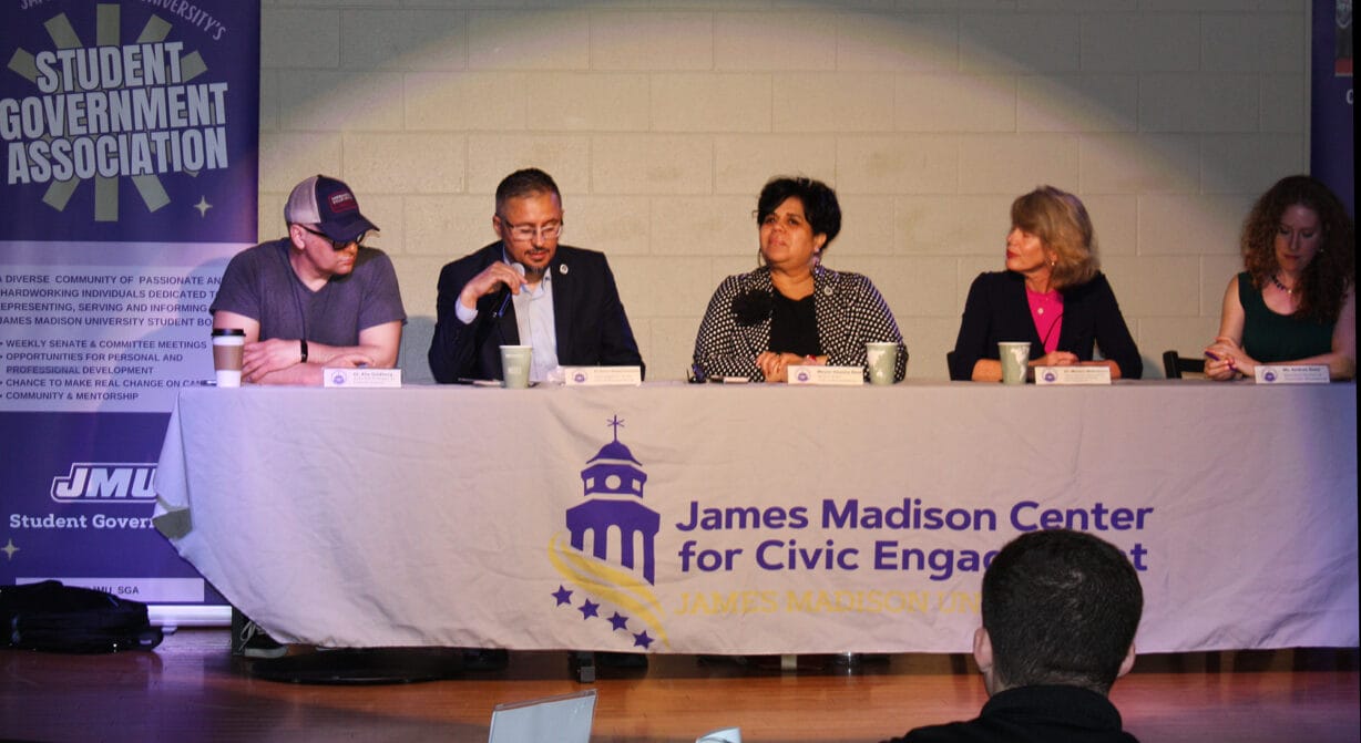 people sitting at a big table on a stage