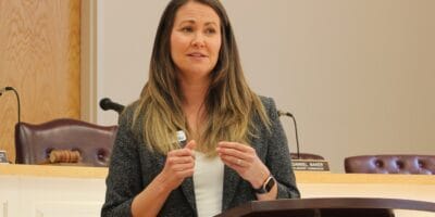 A woman speaks at a podium