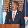 A man in a suit talks at a podium