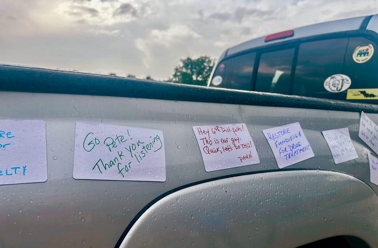 The side of a silver pick-up truck includes notes saying "Go Pete, thanks for listening" and "Hey 6th Dist. folks! This is our guy. Quick, let's do this!" 