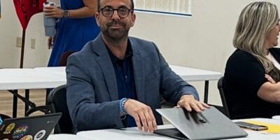 A man closes his laptop