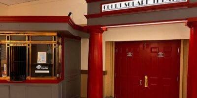 doors and a ticket booth beneath the sign Court Square Theater