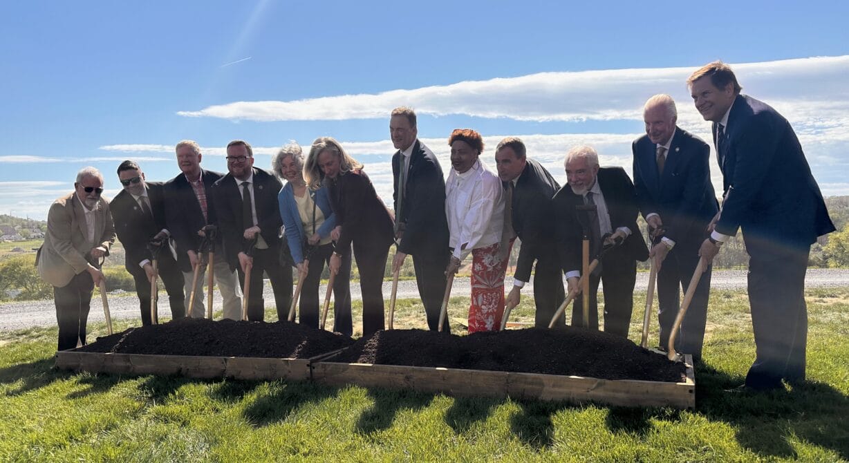people with shovels spread dirt