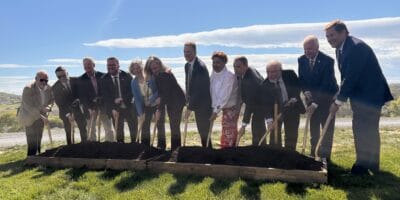 people with shovels spread dirt