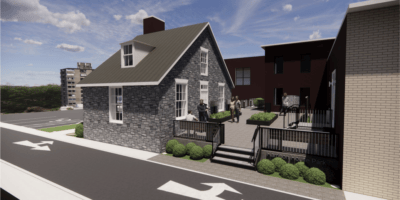 A stone house surrounded by a brick patio